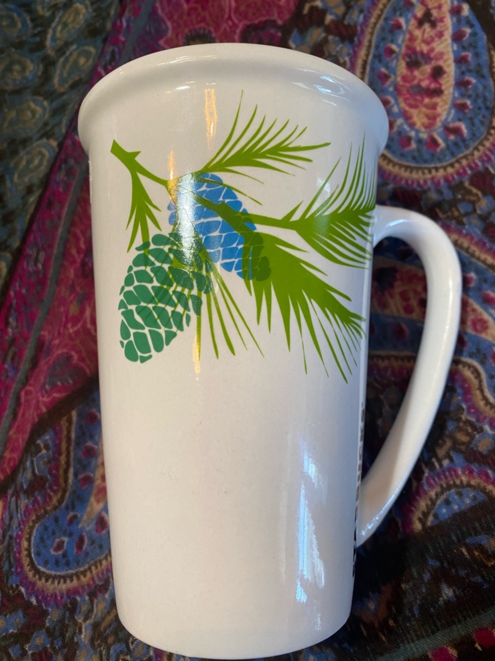 Starbucks 21oz White Mug with Green Pine Branch and Blue Pinecone Accent